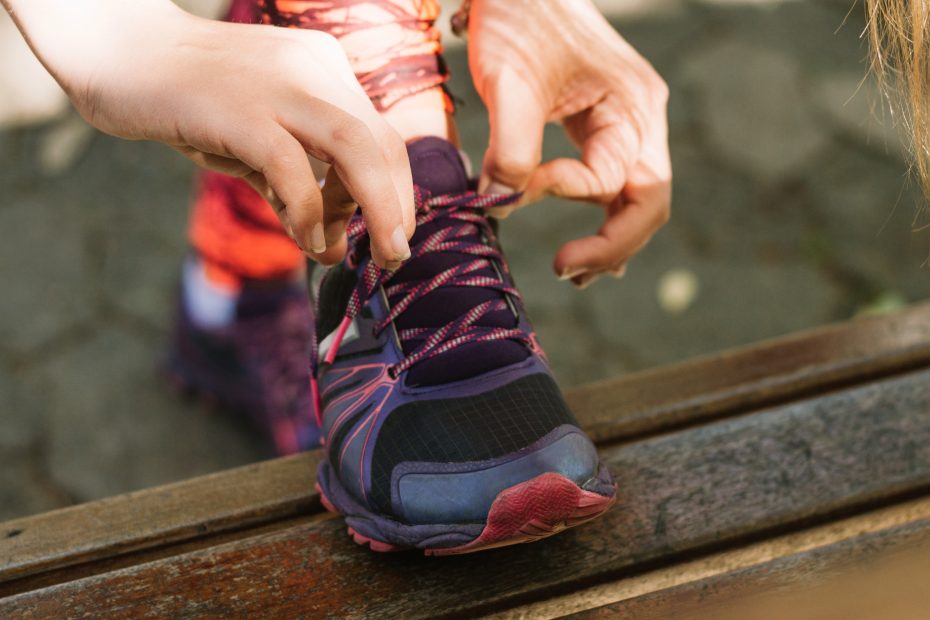 Girl tying sneaker laces