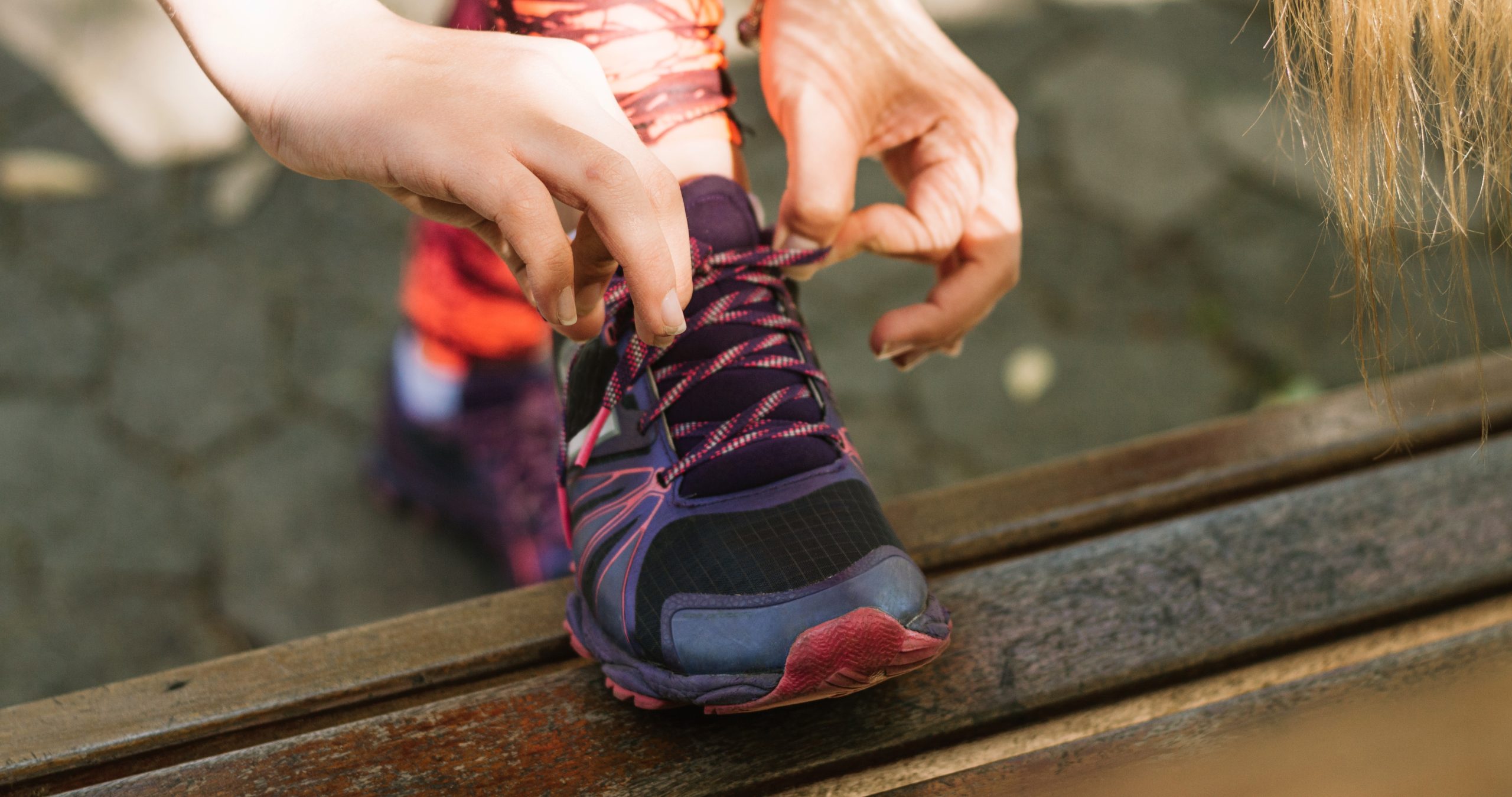 Girl tying sneaker laces